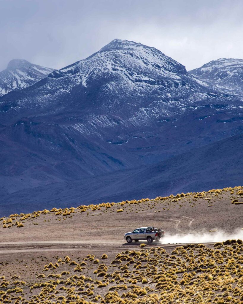 A silver SUV on a mountain road in Northern Chile