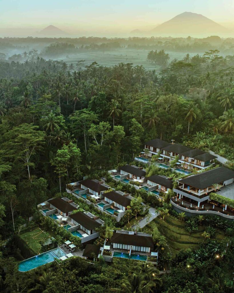 Samsara Ubud's buildings and poools perch right in the heart of the Balinese rainforest with Mount Agung silhouetted in the background
