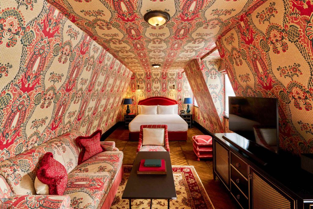 Intricately red, green and cream wallpapered attic suite at the Twenty Two in Mayfair London