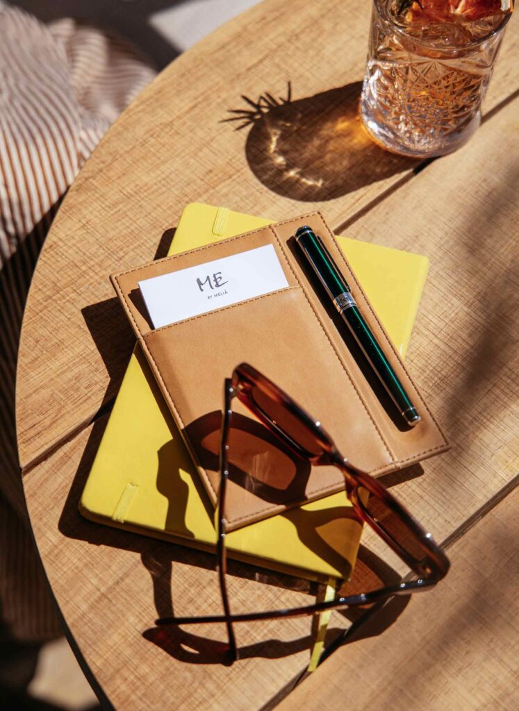 Sunglasses on a leather and yellow ME by Melia note pad