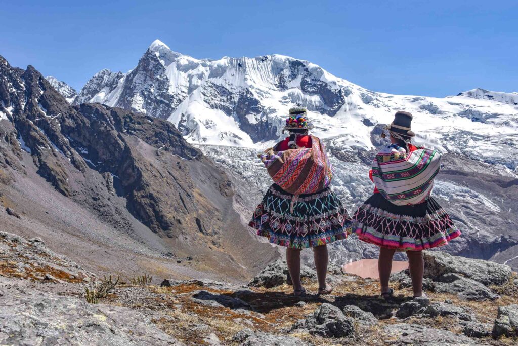 Two Quecha women admire the Andean Mountain view on the Ausungate trail, Cusco Peru – one of Scott Dunn's 40th Anniversary Journeys