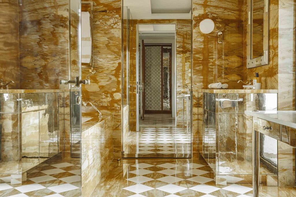 A contemporary gold and mirrored bathroom connect with old Venetian glamour at Belmond's Cipriani Hotel