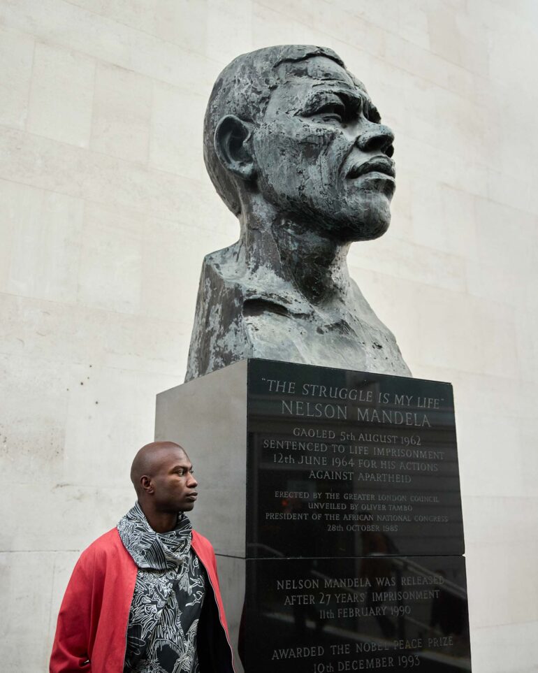 Folu Odimayo poses in front of a large sculpture in London, UK