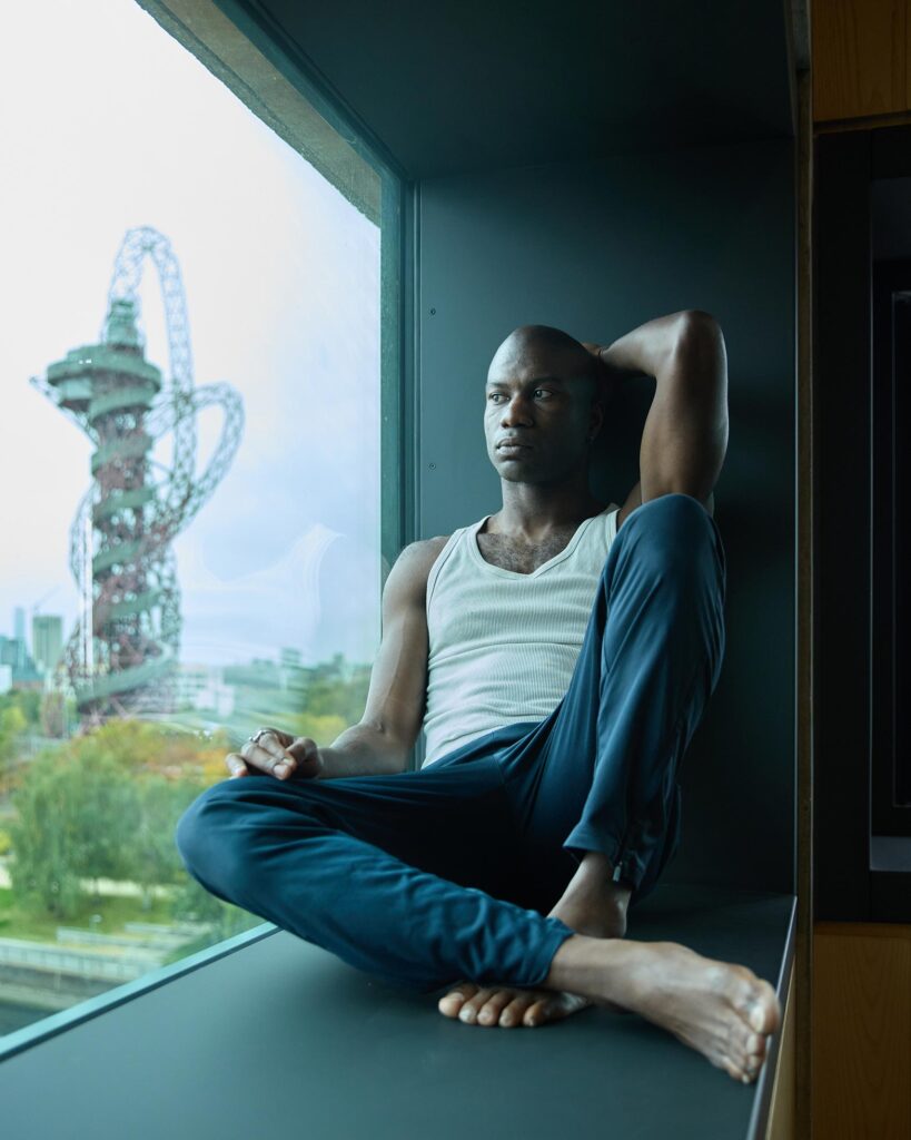 Folu Odimayo poses in a dance studio in front of Anish Kapoor's ArcelorMittal Orbit