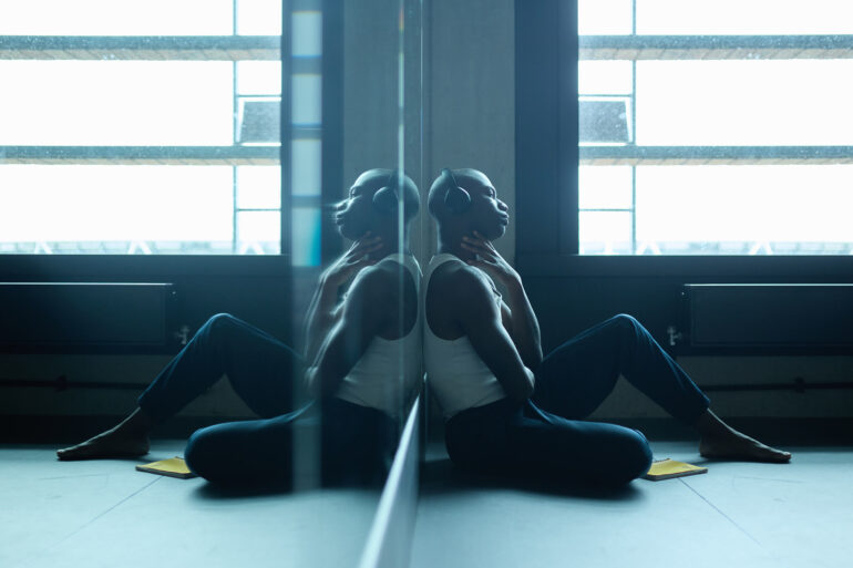 Folu Odimayo leans against a mirror in a ballet studio in London, UK