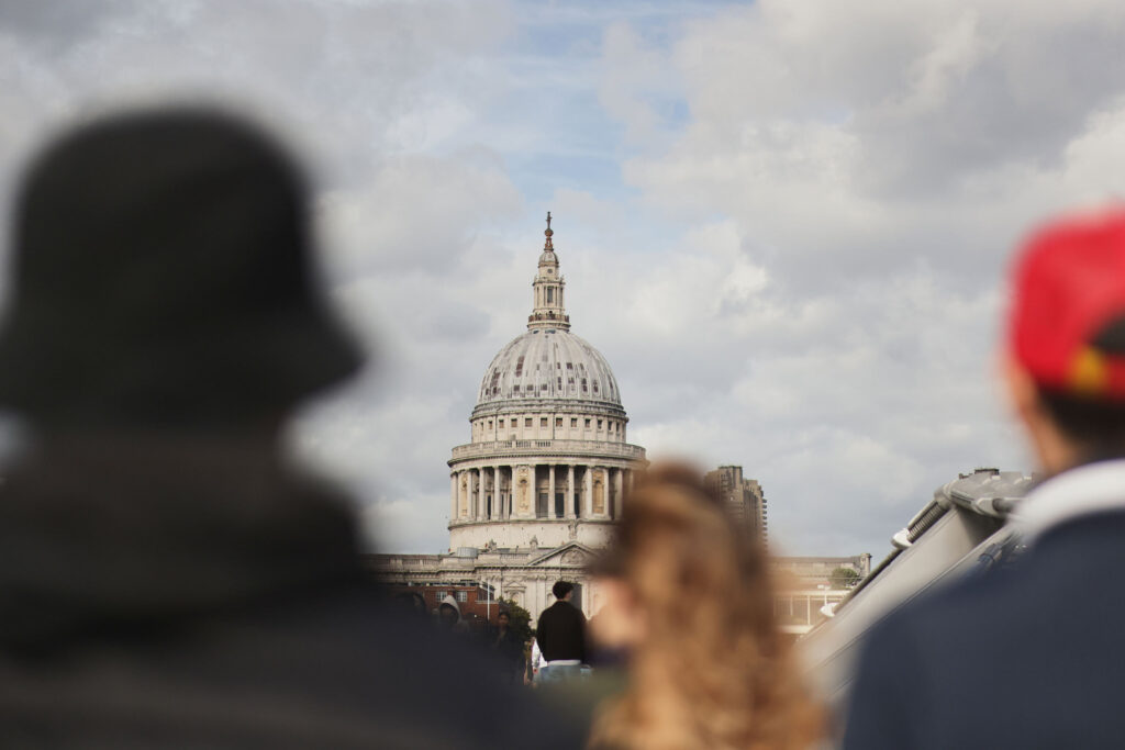 The cupola of Saint Paul's Cathedral is photographed through throngs of people in London, UK