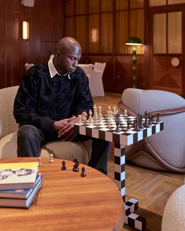 Folu Odimayo plays a game of chess in the lobby of the Sir Devonshire Square Hotel in London, UK