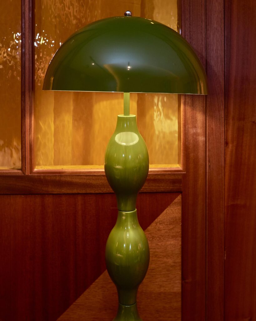 A green retro lampshade on display in the lobby of the Sir Devonshire Square Hotel in London, UK