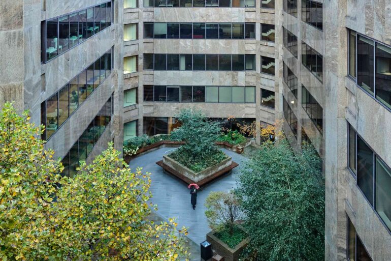 Folu Odimayo is surrounded by office buildings and photographed from above in London, UK