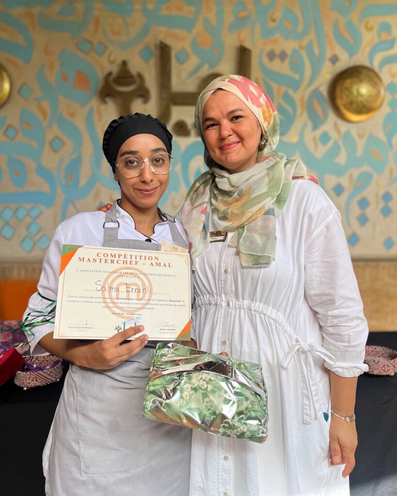 A young female chef is awarded a certificate for winning the Masterchef competition at the Amal Center in Marrakech, Morocco. A cooking class here belongs on any Experiential gift guide