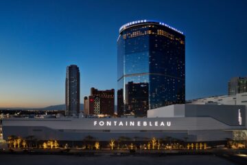 Exterior of Fontainebleau Las Vegas at twilight, with a 67-storey blue glass building rising from the Vegas Strip