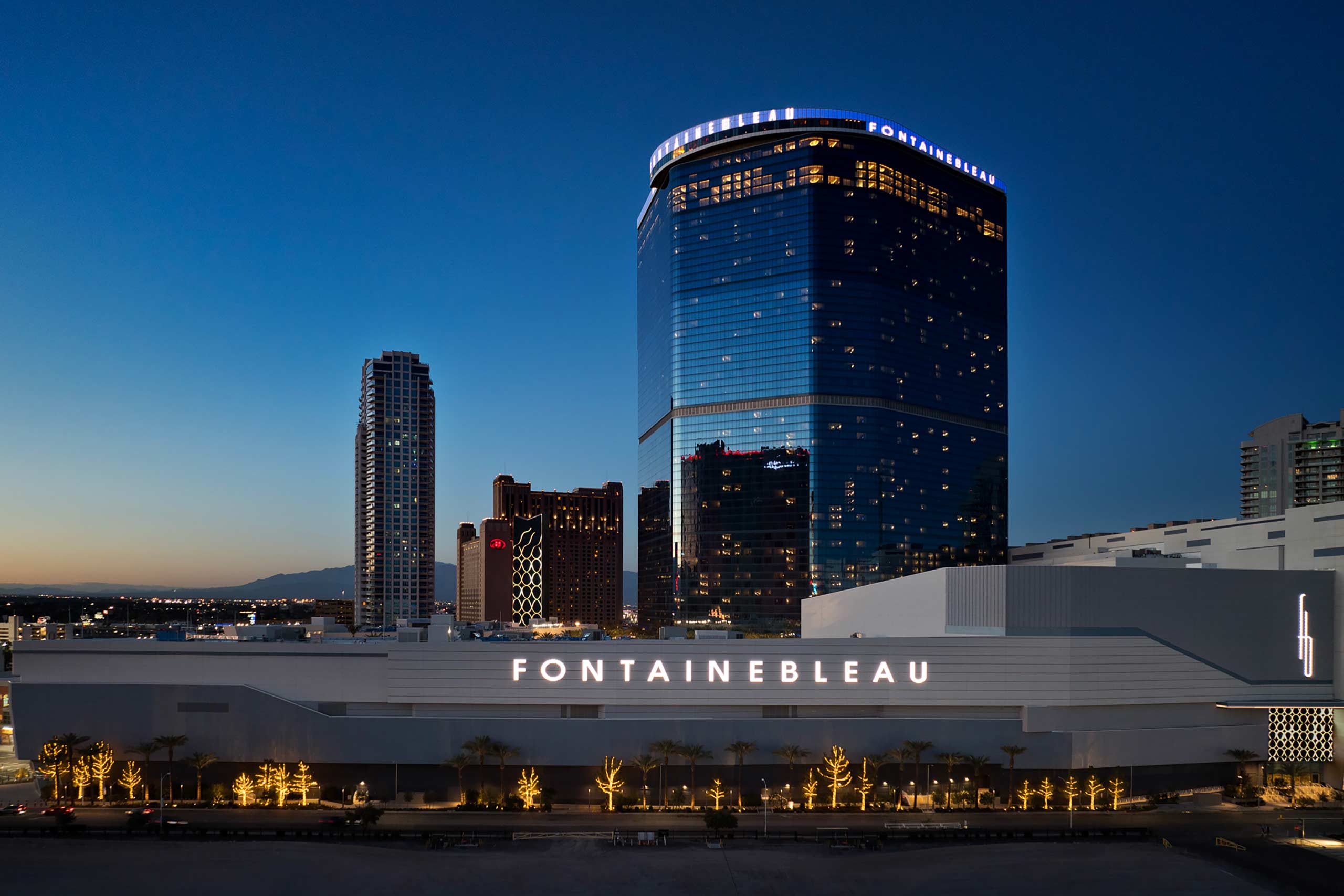 Exterior of Fontainebleau Las Vegas at twilight, with a 67-storey blue glass building rising from the Vegas Strip