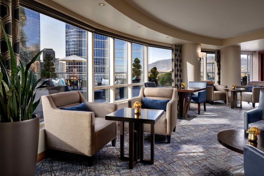 Seating arrangements with views of the city in the Fairmont Gold Lounge at Fairmont Waterfront, Vancouver, Canada