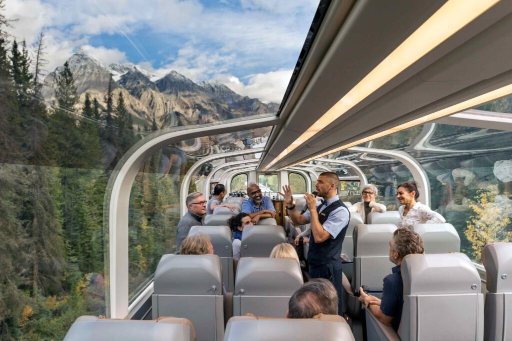 Passengers on the top floor of the glass-dome ceiling coach aboard the Rocky Mountaineer, Canada