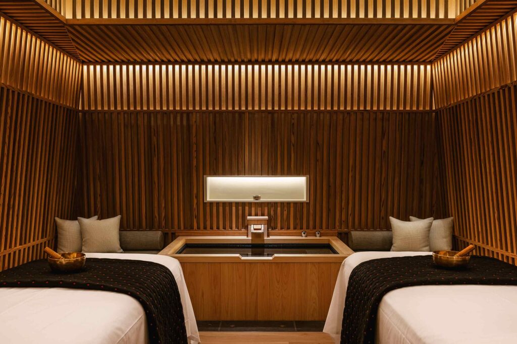 A wood-panelled couples treatment suite with a Japanese bathtub at Six Senses Kyoto, designed by Clint Nagata of BLINK Design Group