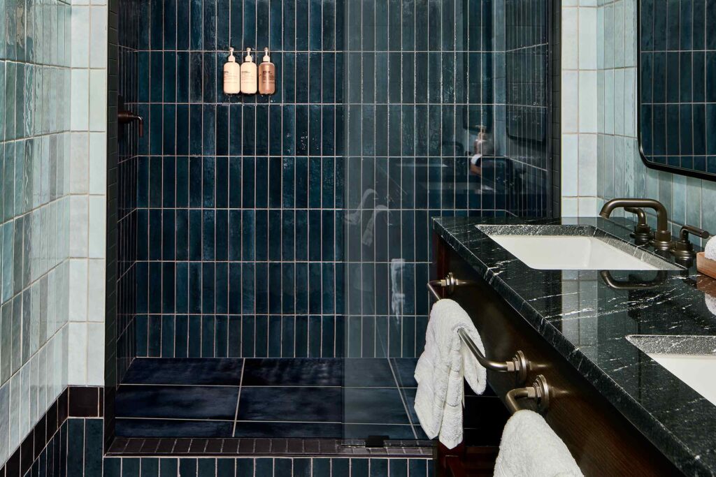 A dark blue tiled walk-in shower at The Manchester, Lexington, Kentucky, USA