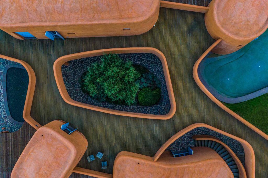 Drone shot above Villas at Is Molas, Sardinia – Massimiliano Fuksas designed villa, orange internal curves and wooden decking