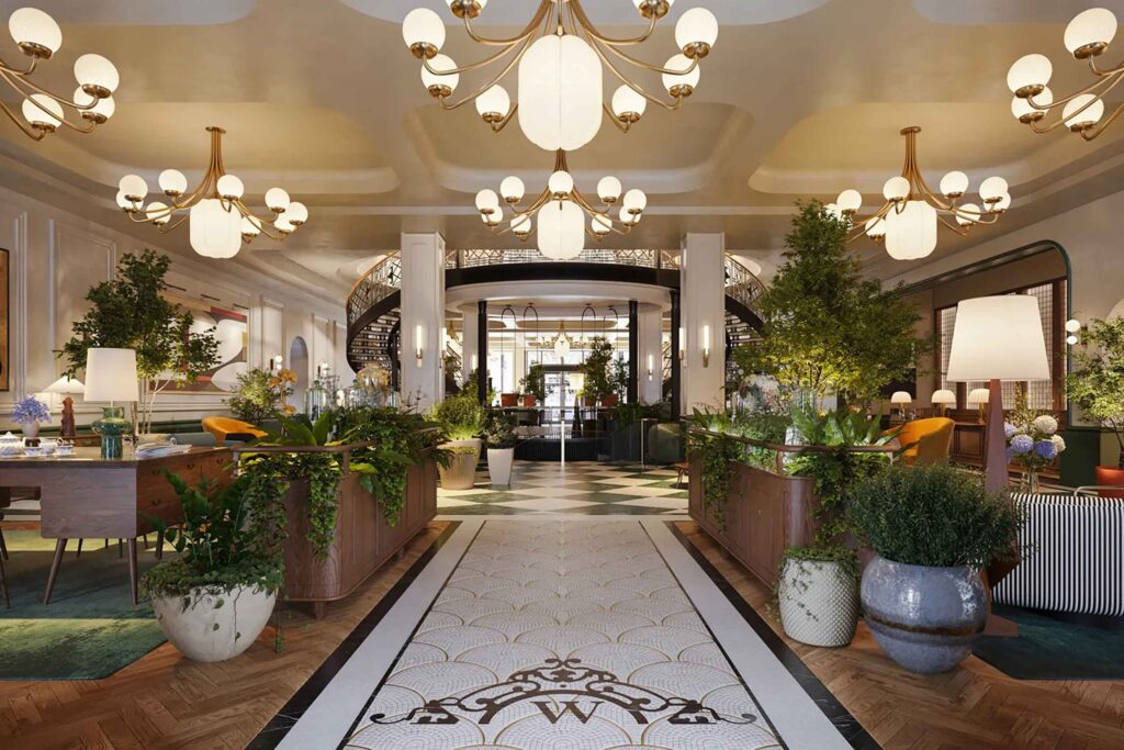 Lobby of Six Senses London, with mongorammed tiles, oak floors, hanging art deco chandeliers and furniture with the historic staircase beyond