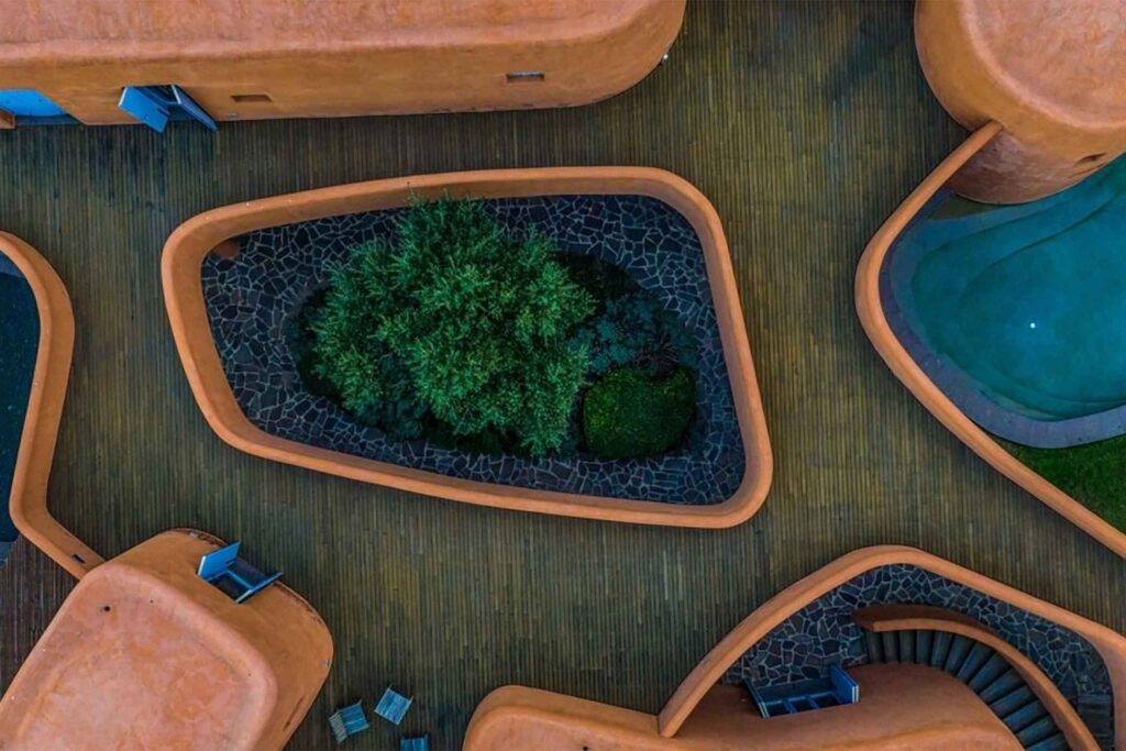 Drone shot above Villas at Is Molas, Sardinia – Massimiliano Fuksas designed villa, orange internal curves and wooden decking