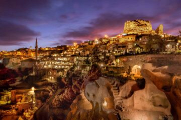 Night falls over a brightly illuminated Argos in Cappadocia, Uchisar, Cappadocia, Türkiye