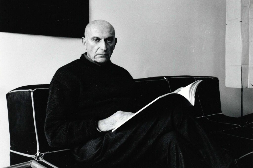 A black and white portrait of Benno Premsela, the first man to openly discuss his homosexuality on Dutch TV. He is one of the Dutch icons whose legacy will be celebrated at WorldPride 2026