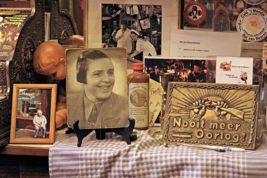 A display with images and paraphernalia relating to Bet van Beeren, founder of Café 't Mandje, at the Amsterdam City Archive. Bet van Beeren will be one of the local queer icons celebrated during WorldPride 2026