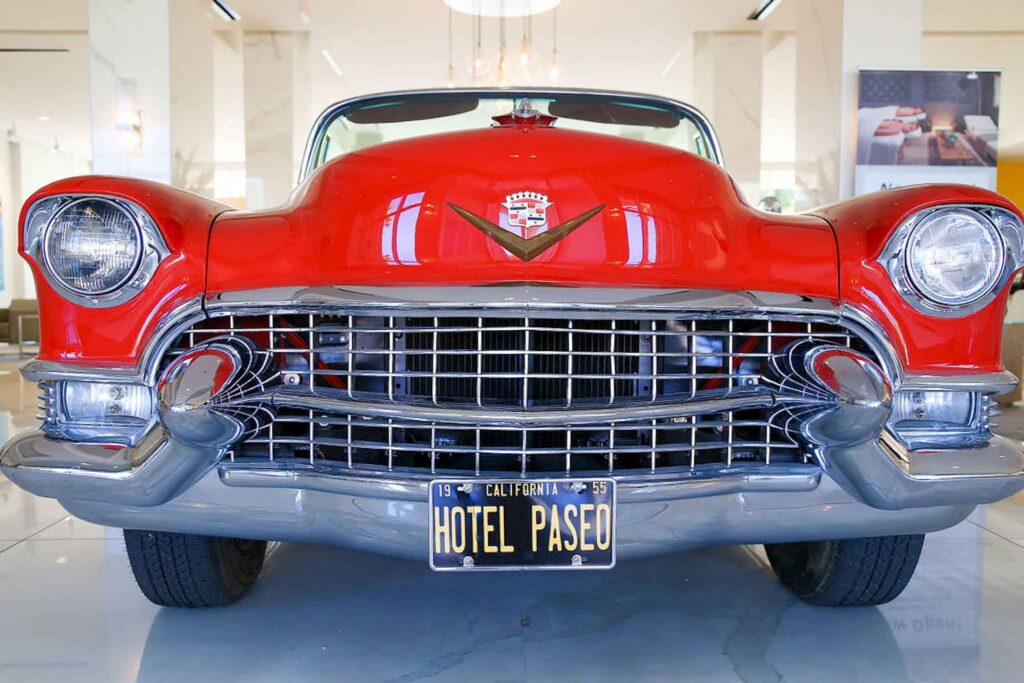 A red 1955 cadillac from the front, with its number-plate reading – California, Hotel Paseo