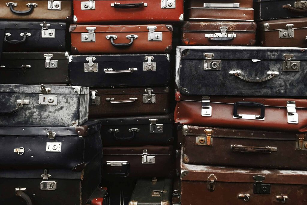 A pile of vintage suitcases stacked up neatly, an apt example of why travelling light is a freer way to explore the world