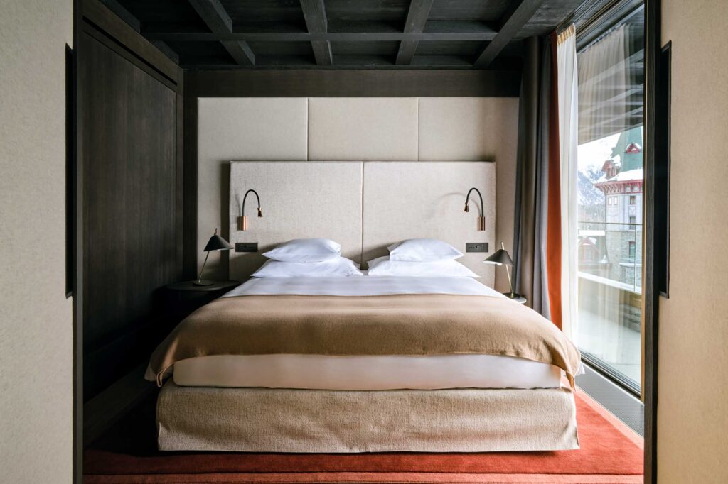 A minimalist but stylish bedroom inside the Serlas Wing at Badrutt's Palace Hotel, St Moritz, Switzerland