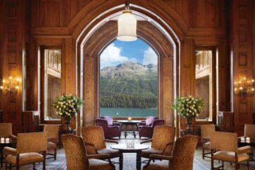 View over Lake St Moritz and the Alps from within a wood-clad restaurant at Badrutt's Palace Hotel, St Moritz, Switzerland
