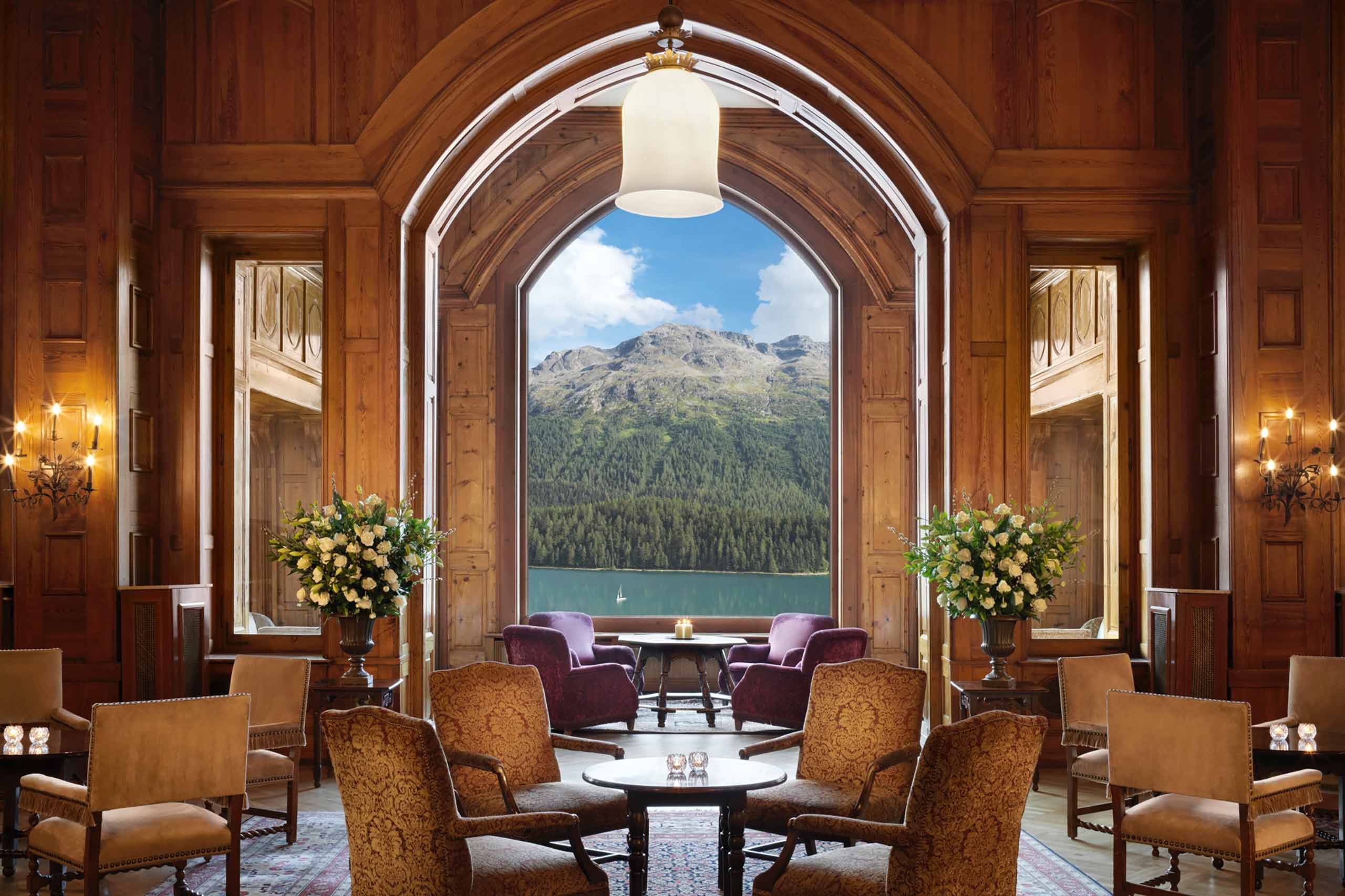 View over Lake St Moritz and the Alps from within a wood-clad restaurant at Badrutt's Palace Hotel, St Moritz, Switzerland