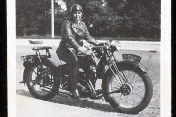 A black-and-white photograph of gay icon and historical Amsterdam bar owner Bet van Beeren on a motorbike