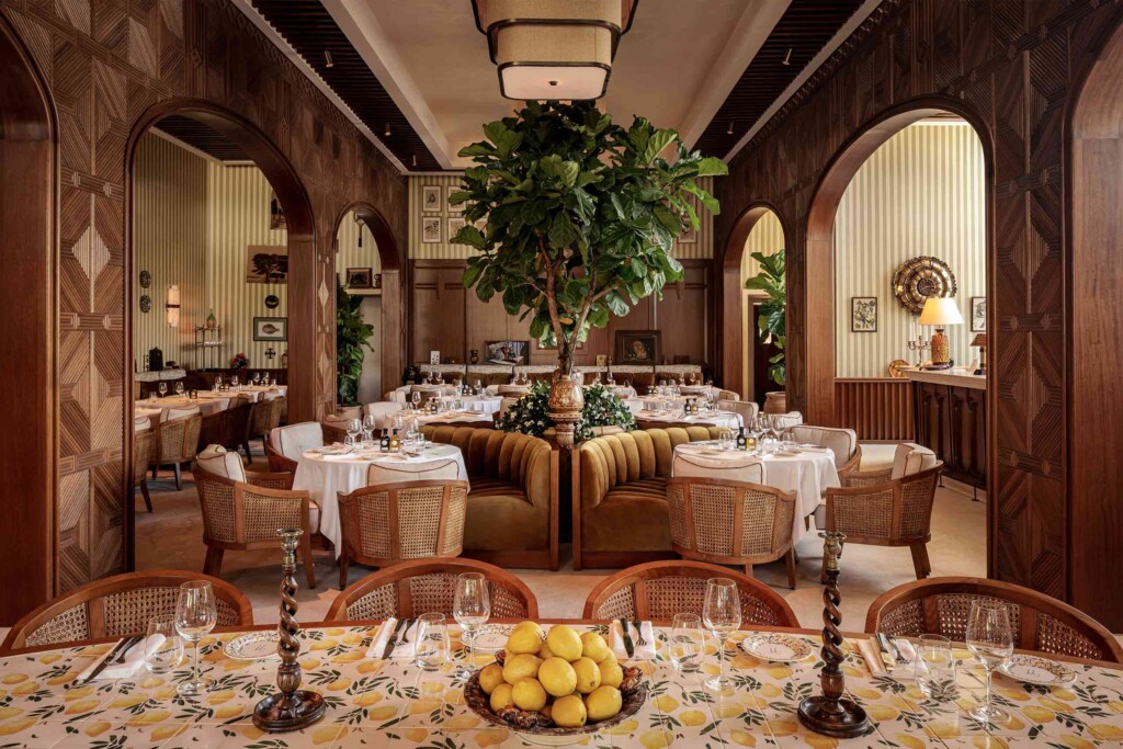 Earthy, textured Gigi Rigoletto Miami Beach restaurant interiors, complete with lemon-tiled tables and trees