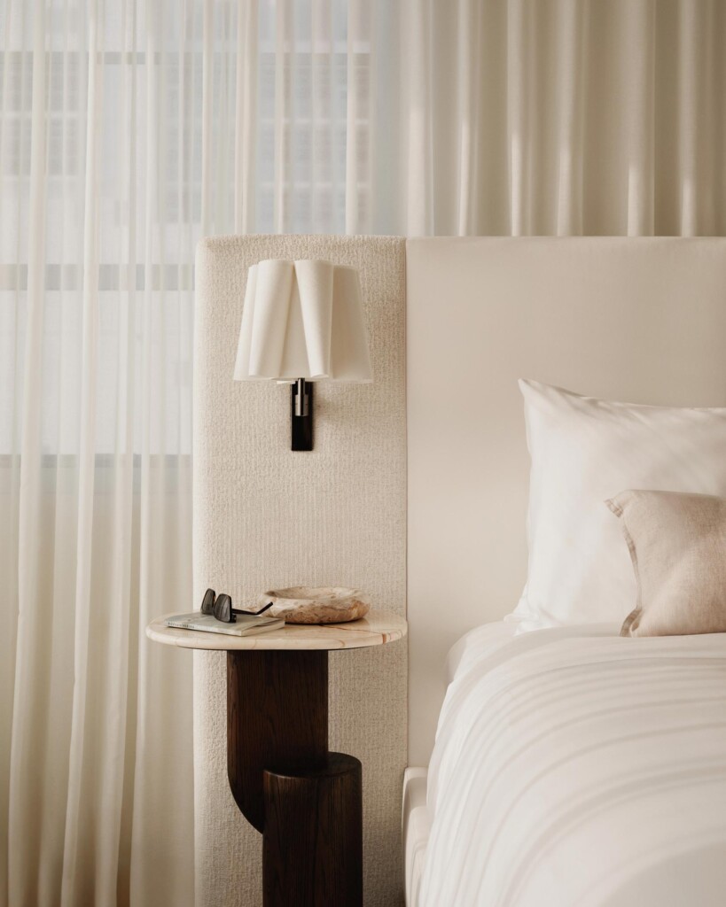 Headboard detail of a bed, lamp and bedside shelf, a tribute to Philip Starck minimalism at Delano Miami Beach