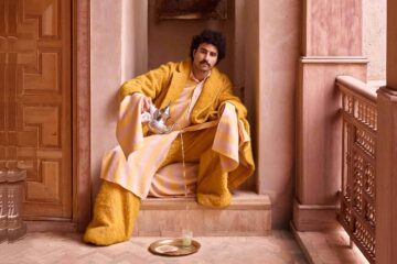 Amran Bennaji pours tea into a beldi glass on a golden tray in Marrakech, Morocco