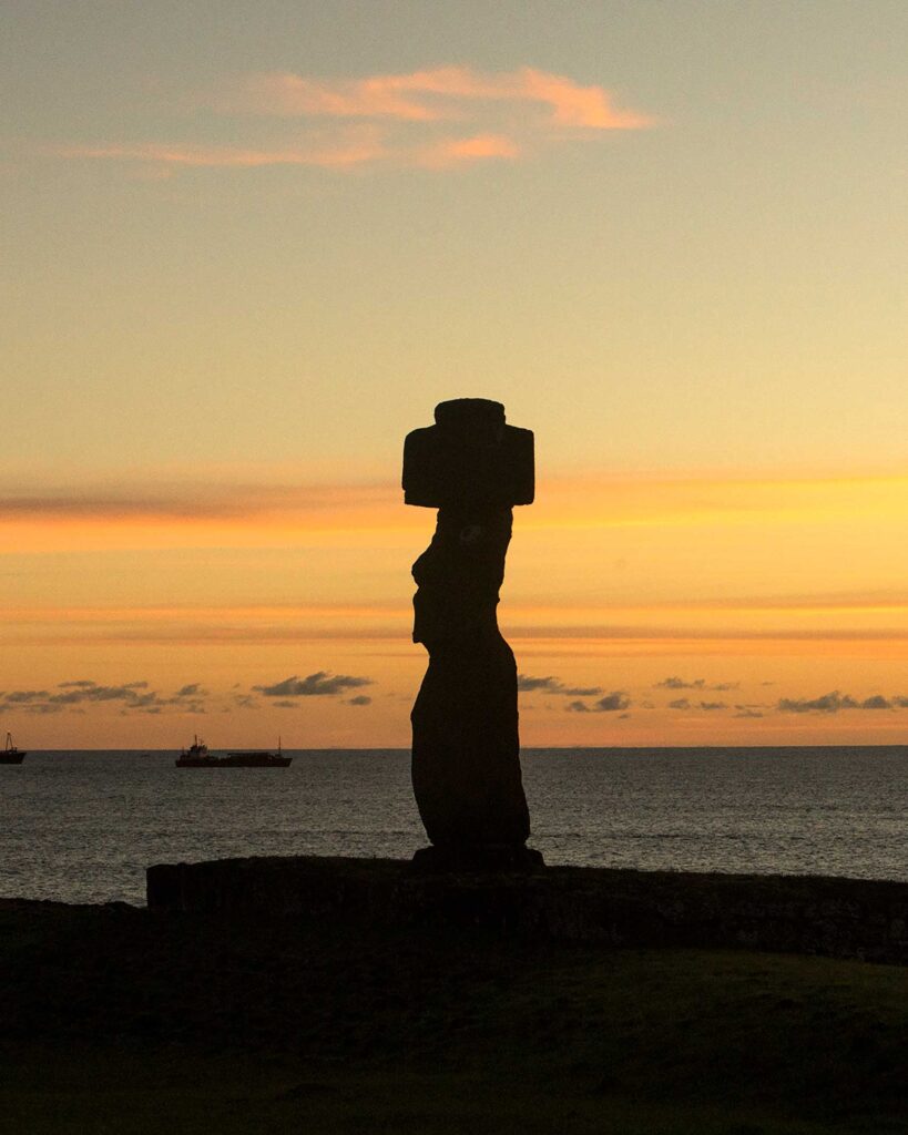 A motu statue silhouetted in the sunset on Easter Island. From the Awakened World issue