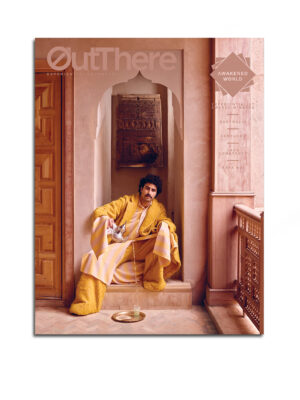 The Awakened World Issue of OutThere magazine, featuring a model pouring tea into a beldi glass while sitting beneath an ornate doorframe in Marrakech, Morocco
