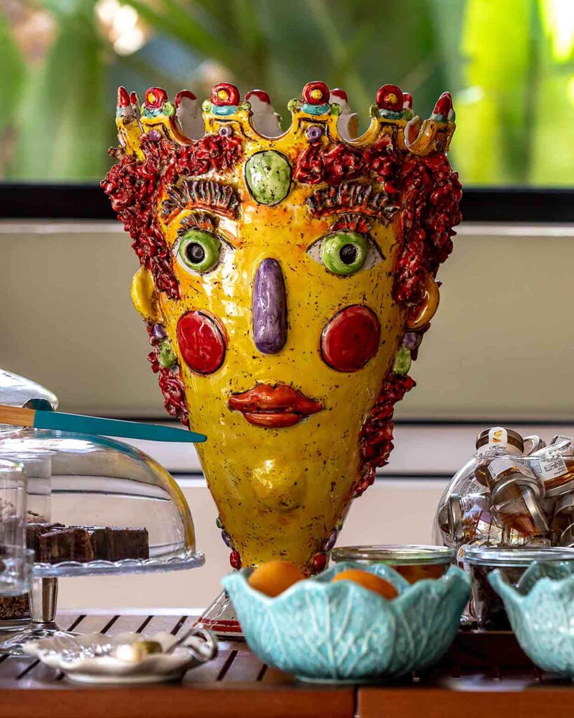 Bespoke pottery – a yellow vase with a face and crown made to look like a cartoon-like prince or king