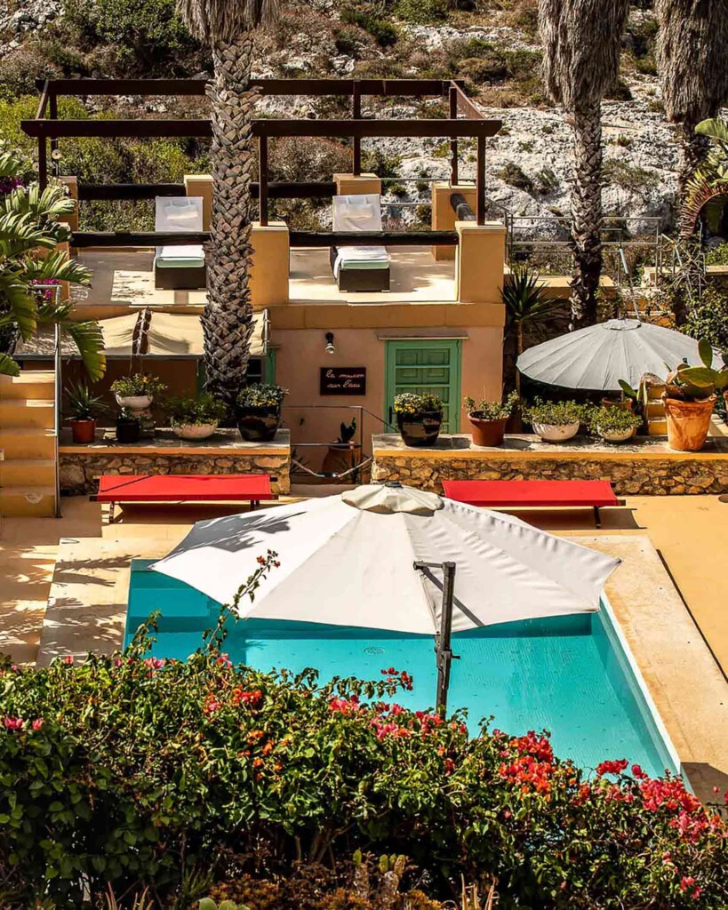Poolside at Thirtyseven Gozo, view from the top of the building looking down onto a rooftop deck