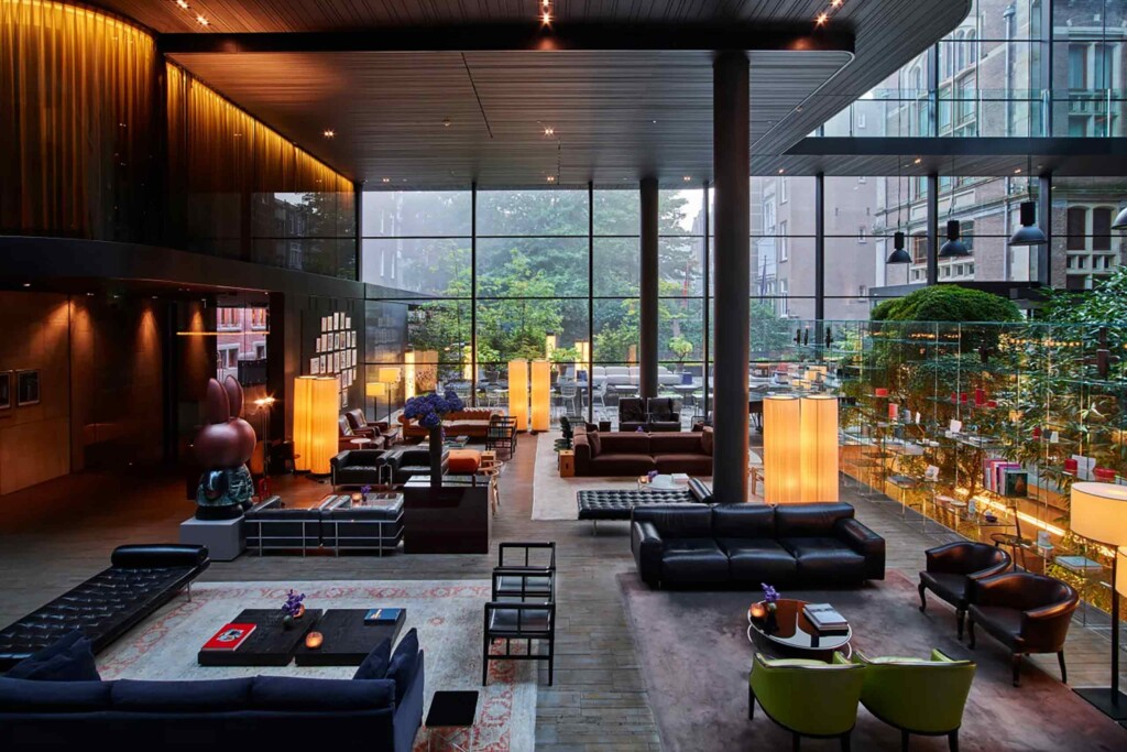 Interiors and communal area of Mandarin Oriental Conservatorium Amsterdam, decidedly modern and contemporary, with huge, double height glass windows