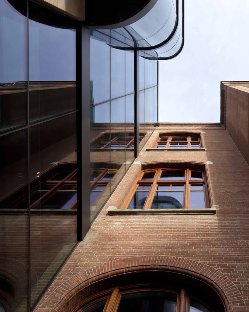 Courtyard detail at Mandarin Oriental Conservatorium Amsterdam, where the old brick building meets the new glass extension