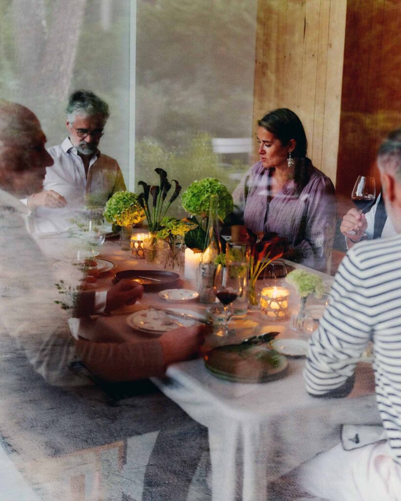 A group of people enjoy a meal around a table