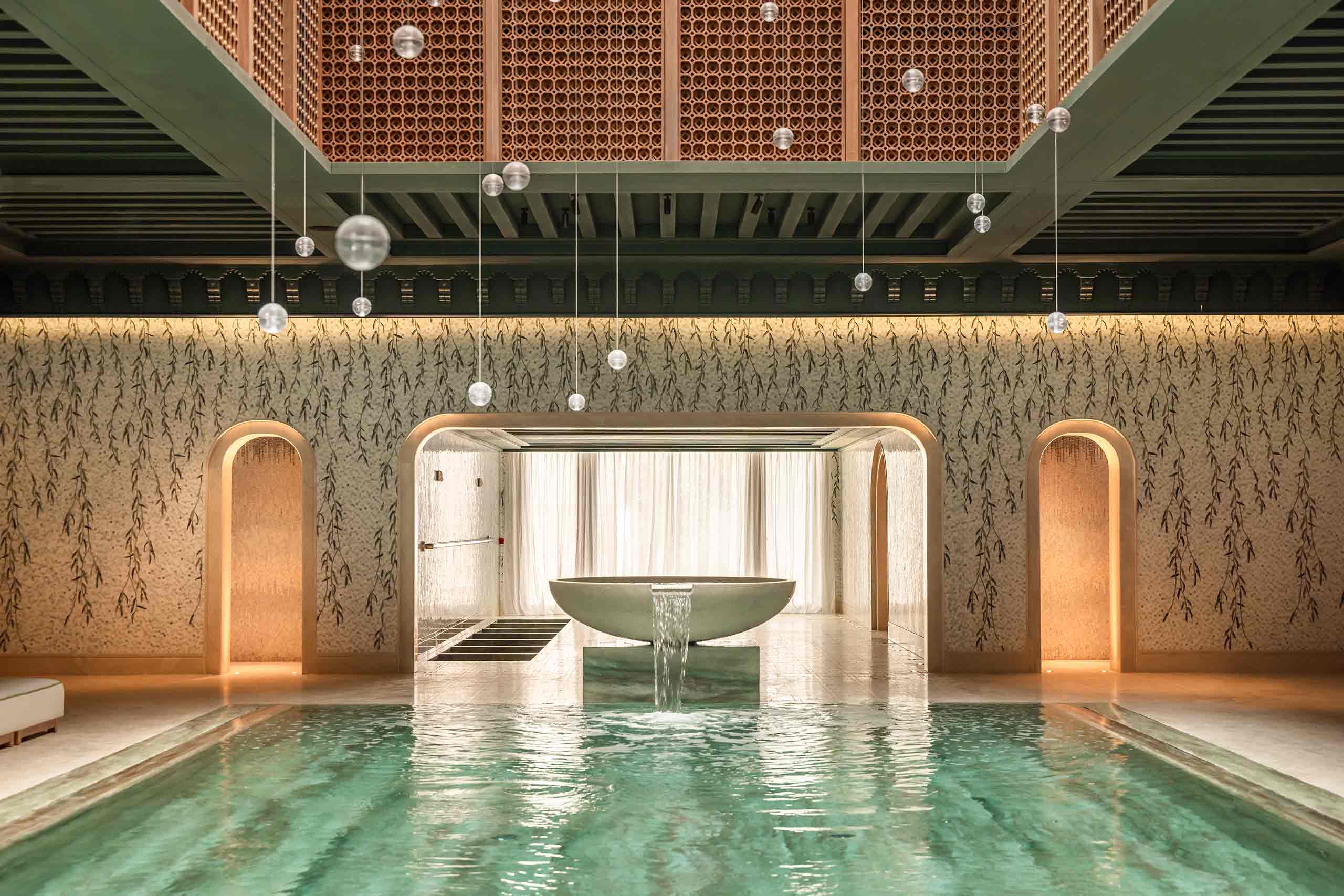 A water feature at the end of a pool above which glass spheres by Canadian brand Bocci float, Royal Mansour Tamuda Bay, Tamuda Bay, Morocco