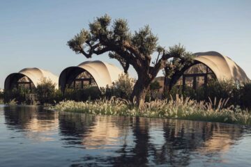 Three domed, sea-shell-like tented villas, or Luxtents overlook a man-made lagoon at 91 Athens Riviera, while a gnarly olive tree stands sentry out front of them