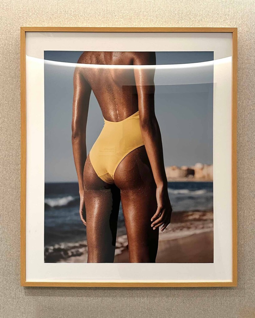 A beech framed photograph of Jan Welters’ Summer Beauty, featuring model Cindy Bruna in a bright yellow swimsuit