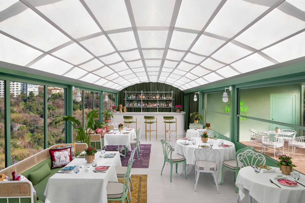 Mint-green seating arrangements and a luxurious bar sit beneath an arched, white ceiling at The Roof, The Ritz-Carlton, Istanbul, Türkiye
