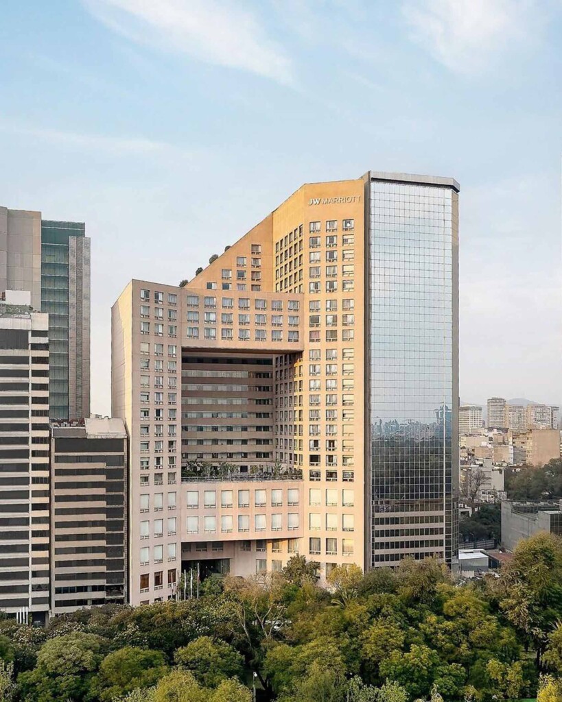 Trees at the bottom of the image frame the exterior view of the JW Marriott Hotel Mexico City Polanco, Mexico City, Mexico